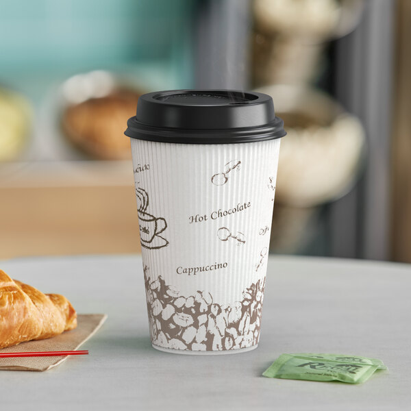 A Choice bean print paper hot cup with a black lid and a croissant on a table.