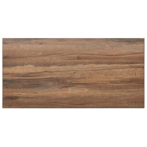 A BFM Seating knotty pine rectangular table top with a dark wood surface.