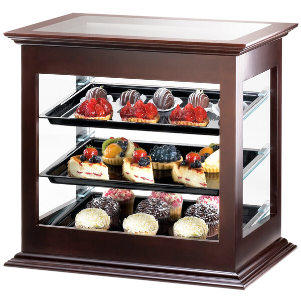 A Cal-Mil wood bakery display case with food on it.
