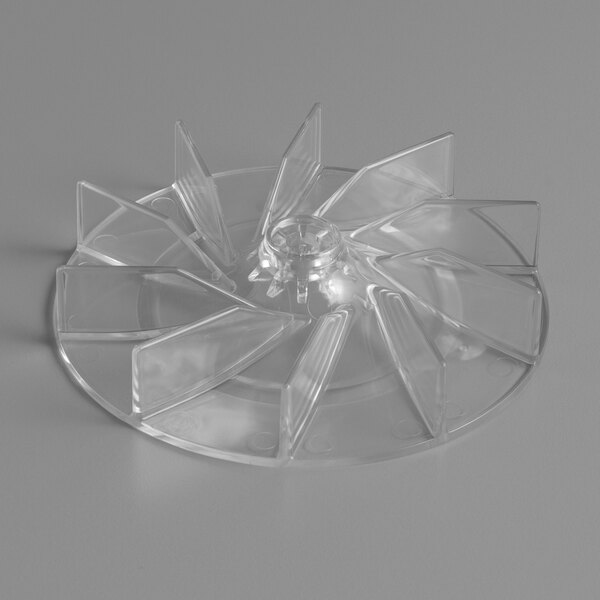 A clear plastic fan with four blades.