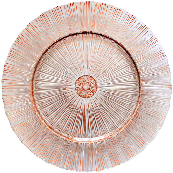 A Bon Chef glass charger plate with a rose gold sunray design.