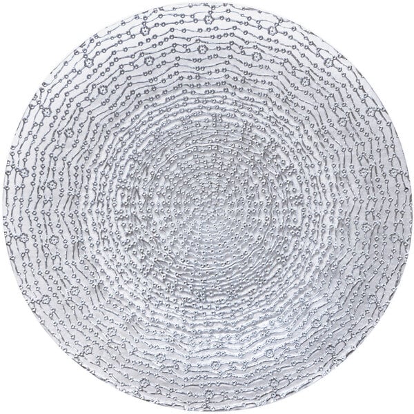 A silver Bon Chef glass charger plate with a circular white and black pattern.