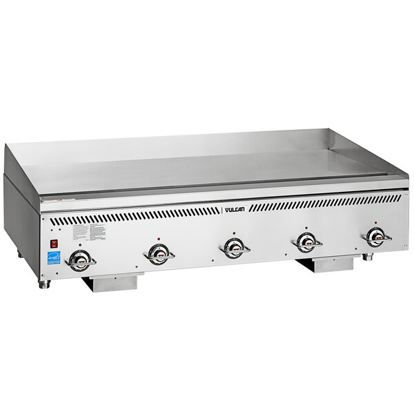 A Vulcan stainless steel gas griddle on a counter with four burners.
