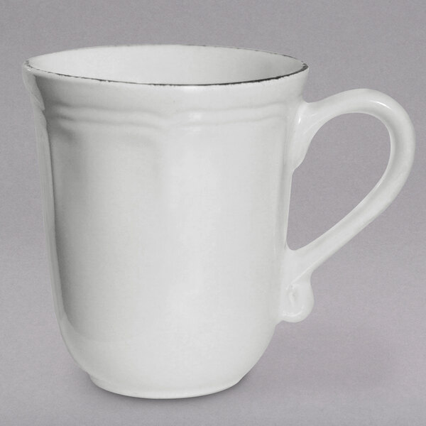 A white mug with a silver rim and a handle.
