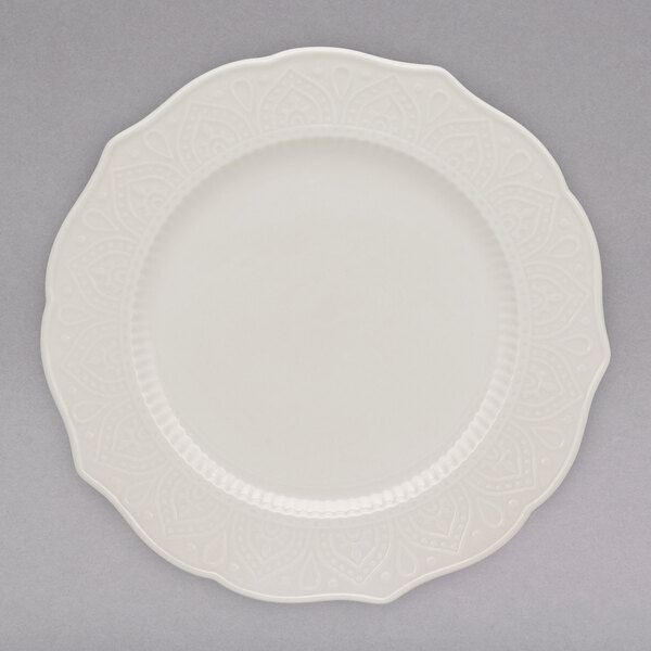 A close up of a white 10 Strawberry Street Dahlia side plate with a design on it.