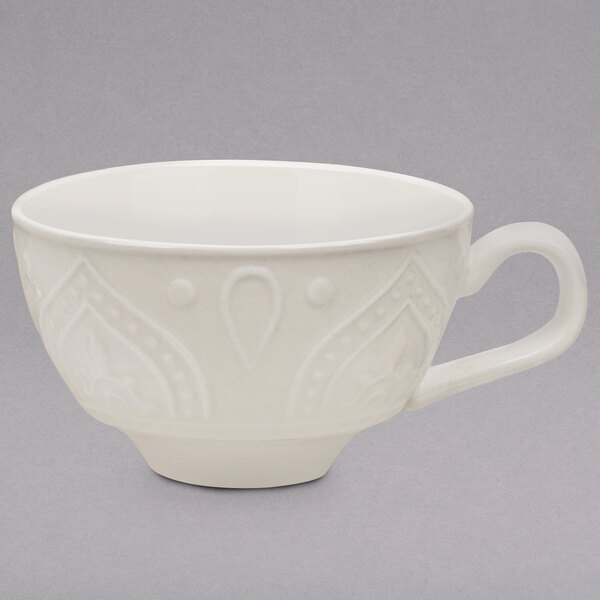 A white 10 Strawberry Street New Bone China tea cup with a design on it and a handle.