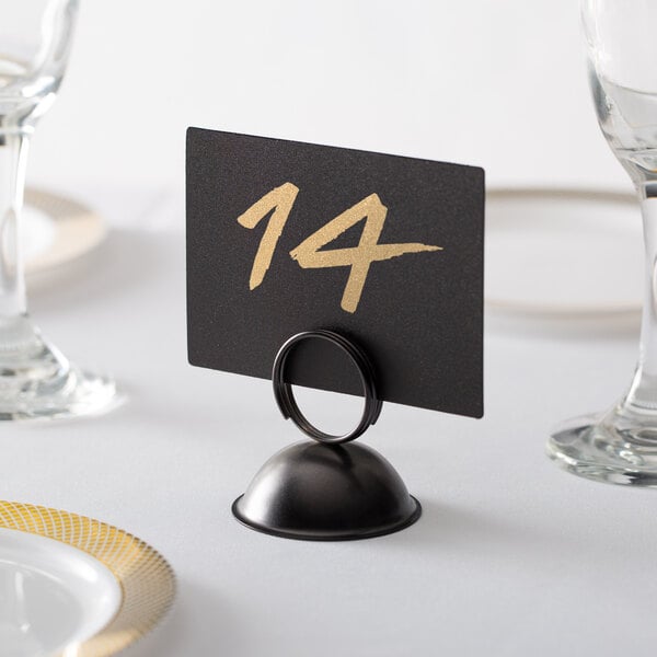A black Choice table number stand holding a table number.