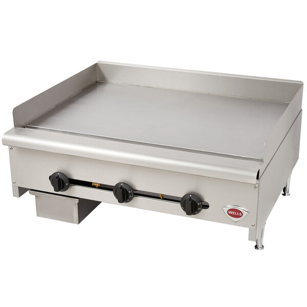 A large stainless steel Wells countertop griddle.