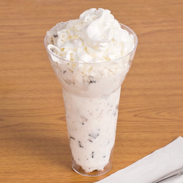 A WNA Comet Classic Crystal parfait cup filled with ice cream and whipped cream.