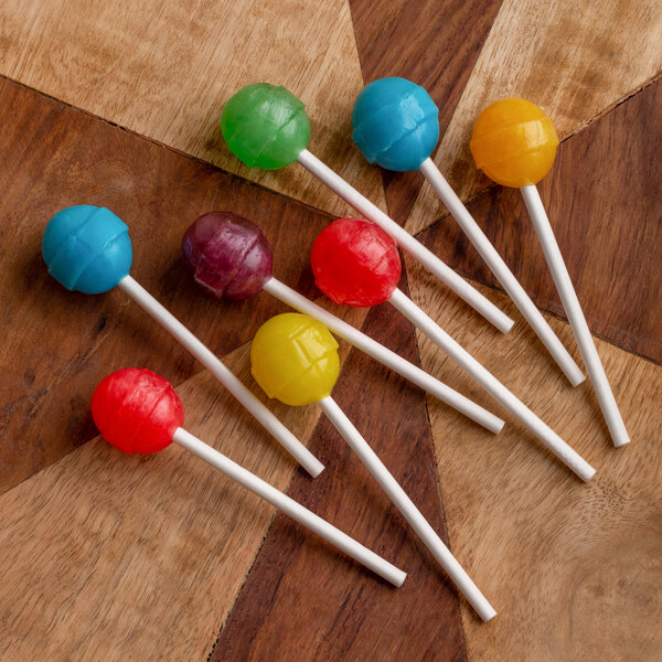 A group of lollipops on white paper sticks.