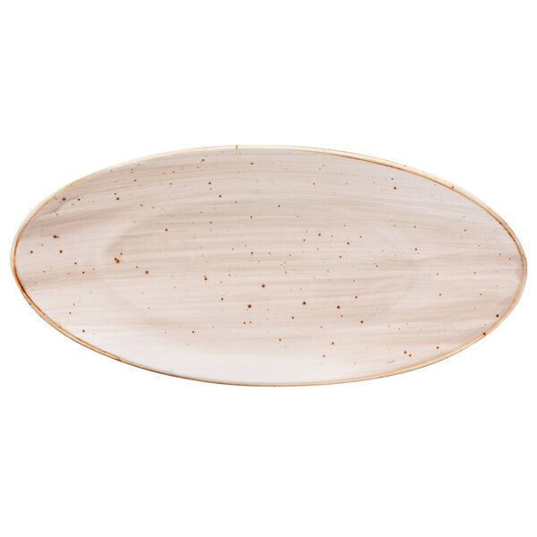A white oval plate with brown specks.