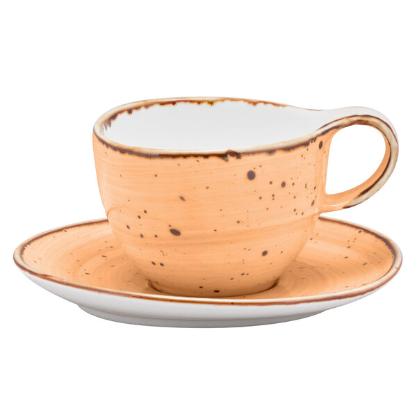A 10 Strawberry Street Santa Fe Maize orange china cup and saucer with a brown speckled rim and handle.