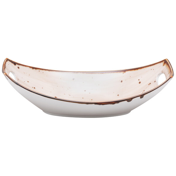 A white oval china bowl with brown specks on it.
