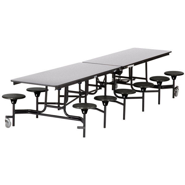 A National Public Seating rectangular cafeteria table with black round stools.