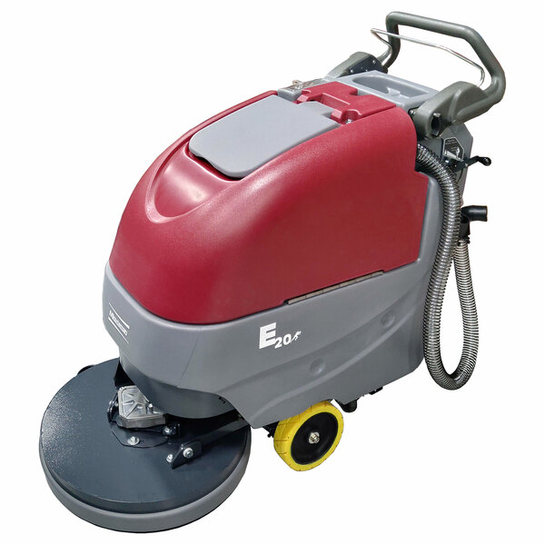 A Minuteman cordless walk behind floor scrubber with wheels and a red and yellow handle.