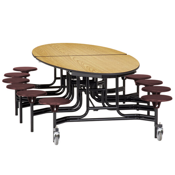 A National Public Seating cafeteria table with stools around it.