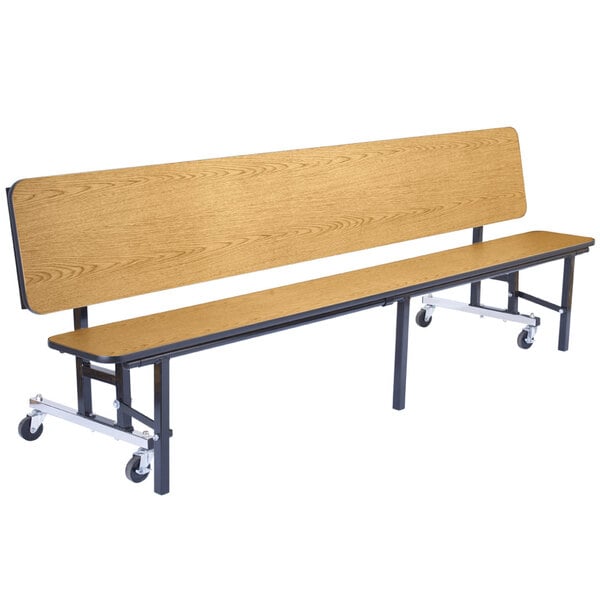 A National Public Seating wooden bench with black legs and wheels.