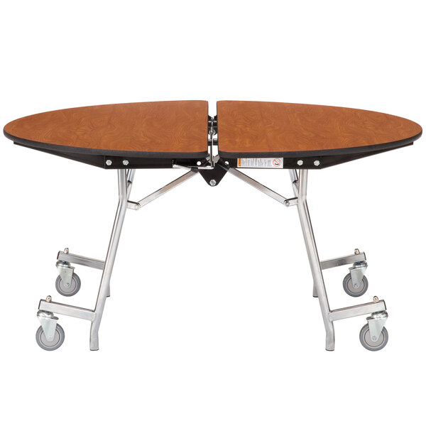 A National Public Seating round plywood cafeteria table with a metal frame and wheels.