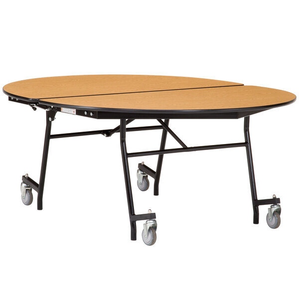 A National Public Seating oval cafeteria table with wheels on it.