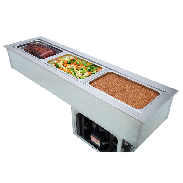 A Wells Slim Line drop-in cold/hot well with 4 pans of food on a buffet counter.
