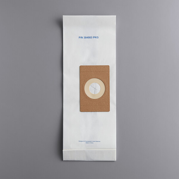 A brown paper bag with a white circle containing a cross.