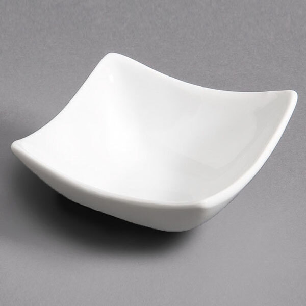 A CAC Super White square porcelain dish on a gray surface.