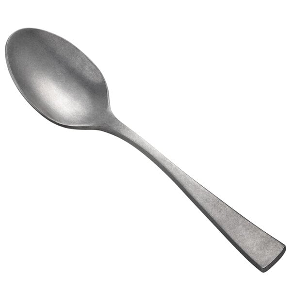 An Oneida Lexia stainless steel serving spoon with a metal handle.
