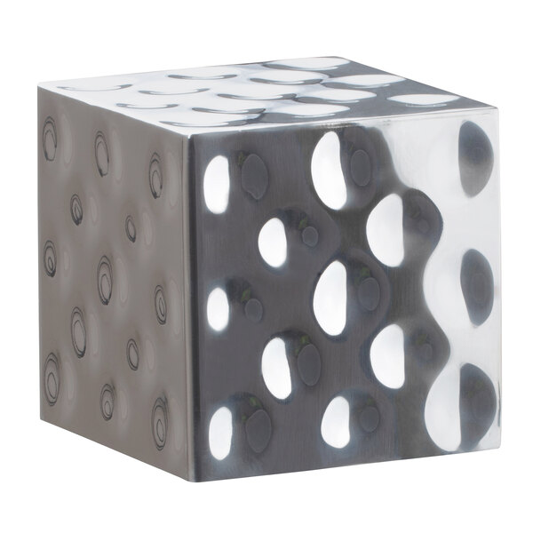 A silver stainless steel cube with holes in it.