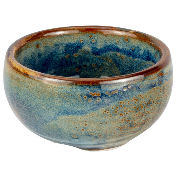 A close-up of a blue and brown Bon Chef porcelain ramekin.