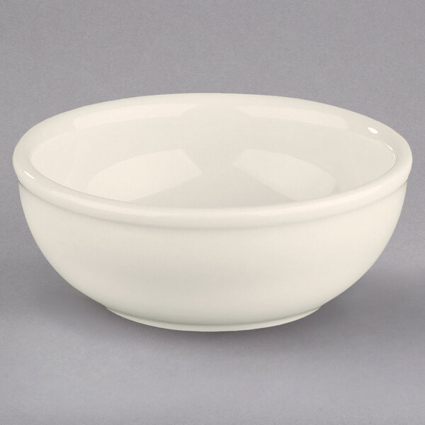 A white Homer Laughlin china nappie bowl with a rolled edge.