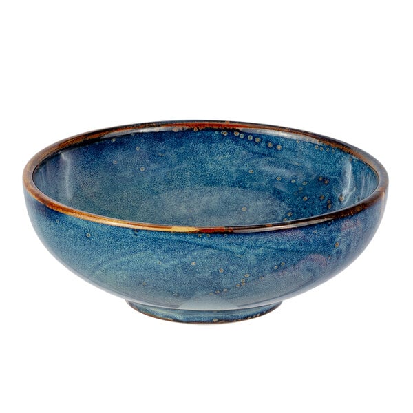 A white porcelain bowl with blue and brown specks and a gold rim.