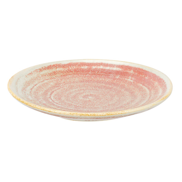A close up of a Bon Chef Tavola Blush porcelain dinner plate with a pink and gold rim.