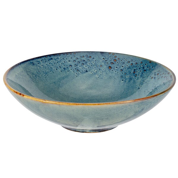A blue porcelain bowl with brown specks.