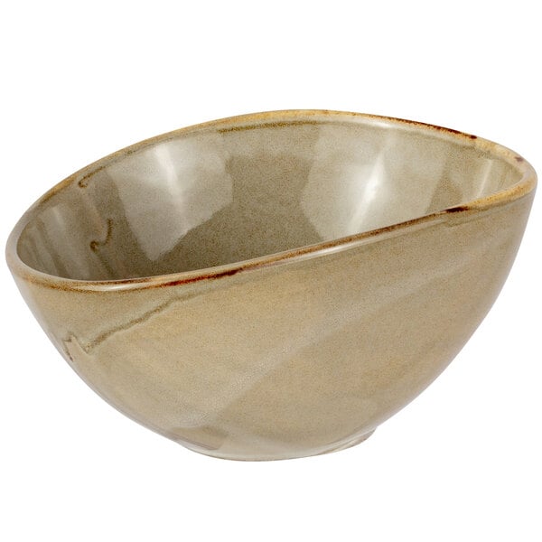 A Bon Chef porcelain soup bowl with a white background and a curved edge with a brown rim.
