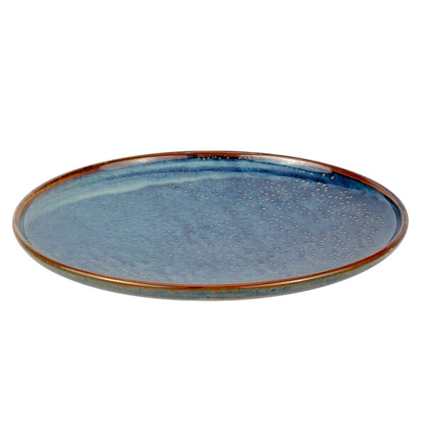 A white porcelain plate with a blue and brown rim.
