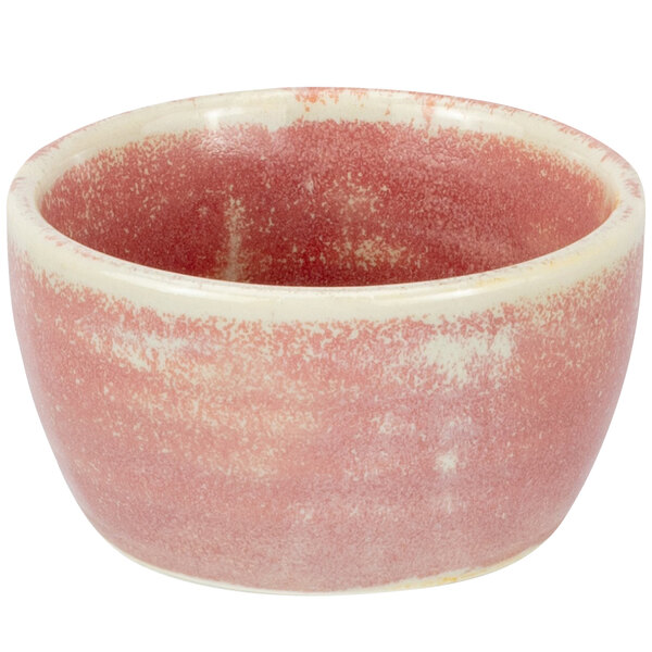 A white porcelain ramekin with a pink and white design.