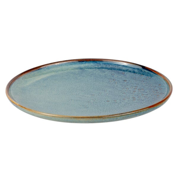 A blue porcelain dinner plate with a brown rim.