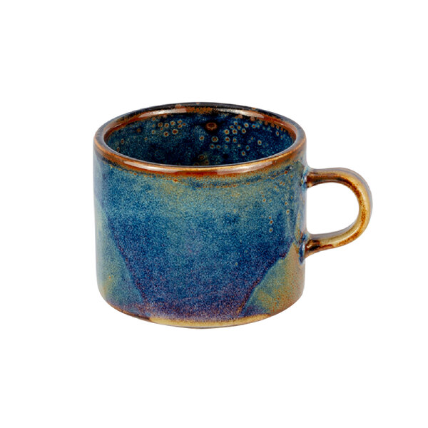 A close-up of a blue and brown porcelain tea cup with a handle.