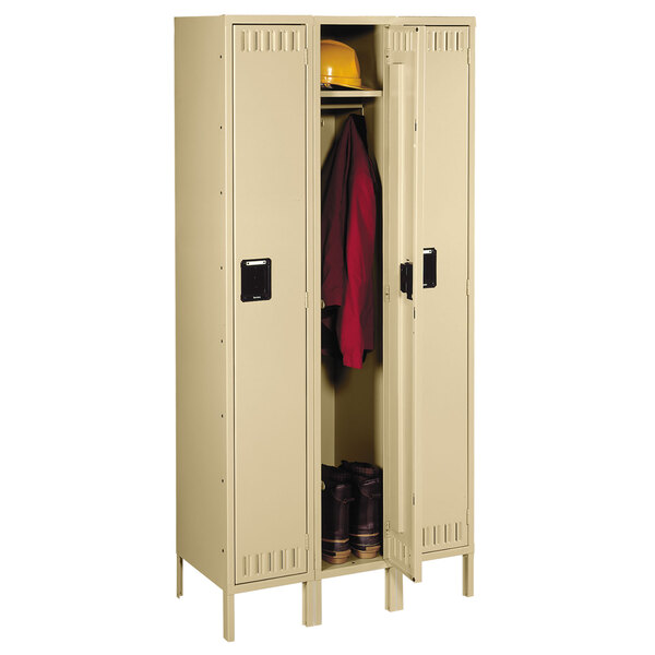 A tan Tennsco steel locker with legs.