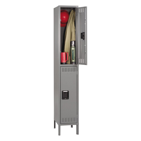 A grey Tennsco steel double tier locker with legs, containing a red hat and coat.