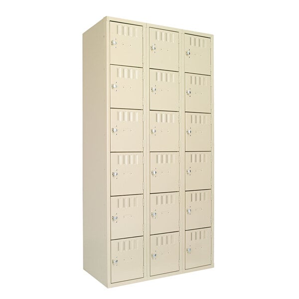 A white Tennsco metal locker with eighteen compartments and three doors.