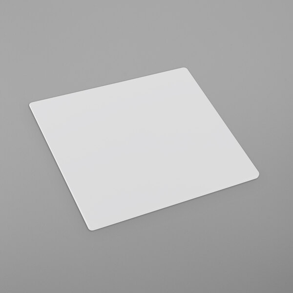 A white square object on a gray surface.