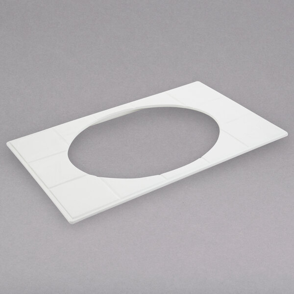 A white oval tile with a hole in the middle.