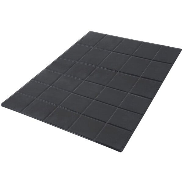 A black rectangular tile with squares on it.
