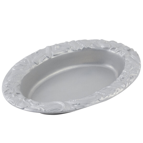 A silver oval dish with a decorative design.