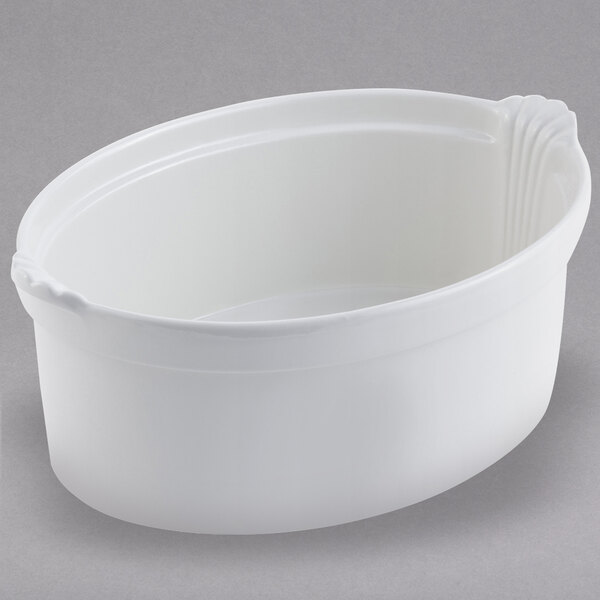 A white Bon Chef oval casserole dish with shell handles.