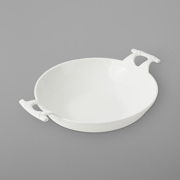 A white Bon Chef wok bowl with handles.