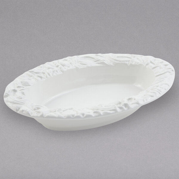A white Bon Chef oval pasta bowl with a decorative design.