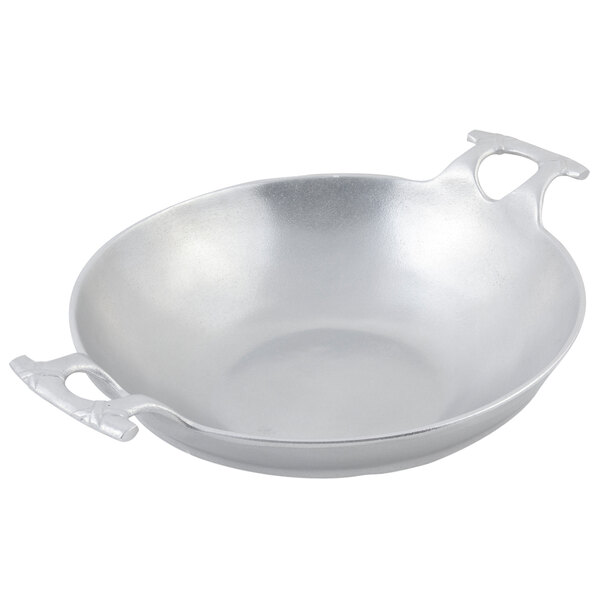 A Bon Chef pewter-glo wok with handles.