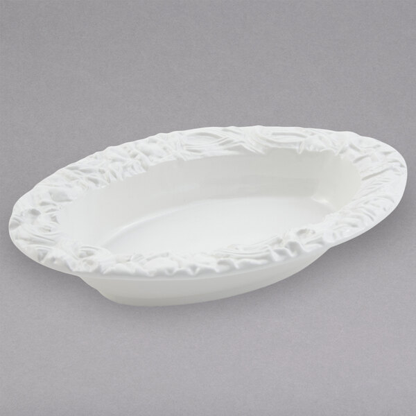 A white oval dish with a decorative edge.